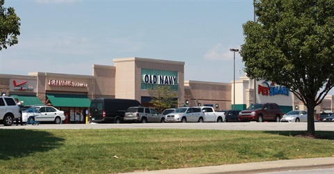 Store fronts at Merriam Town Center with cars parked in front.