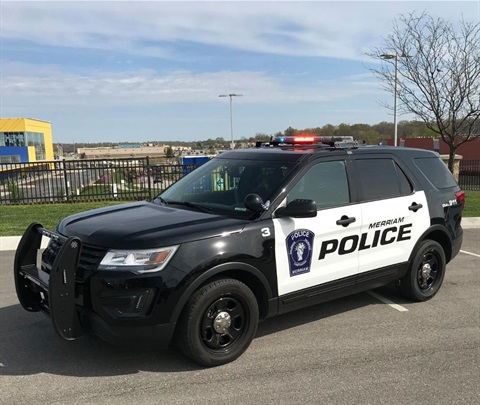 Merriam Police vehicle in parking lot. The vehicle is black and white.